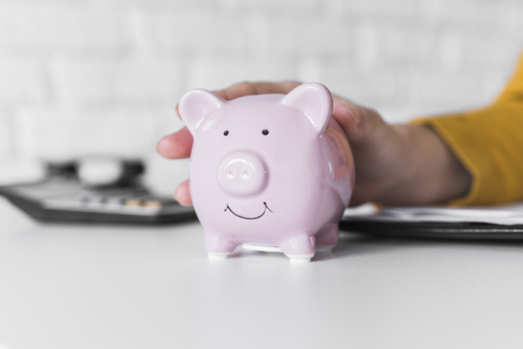 close up woman holding piggy bank