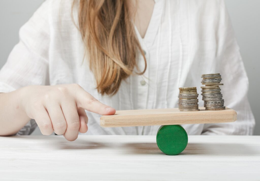 Why an Affordable Virtual Receptionist is a Smart Investment for Small Businesses 1 woman holding her finger balance with coins