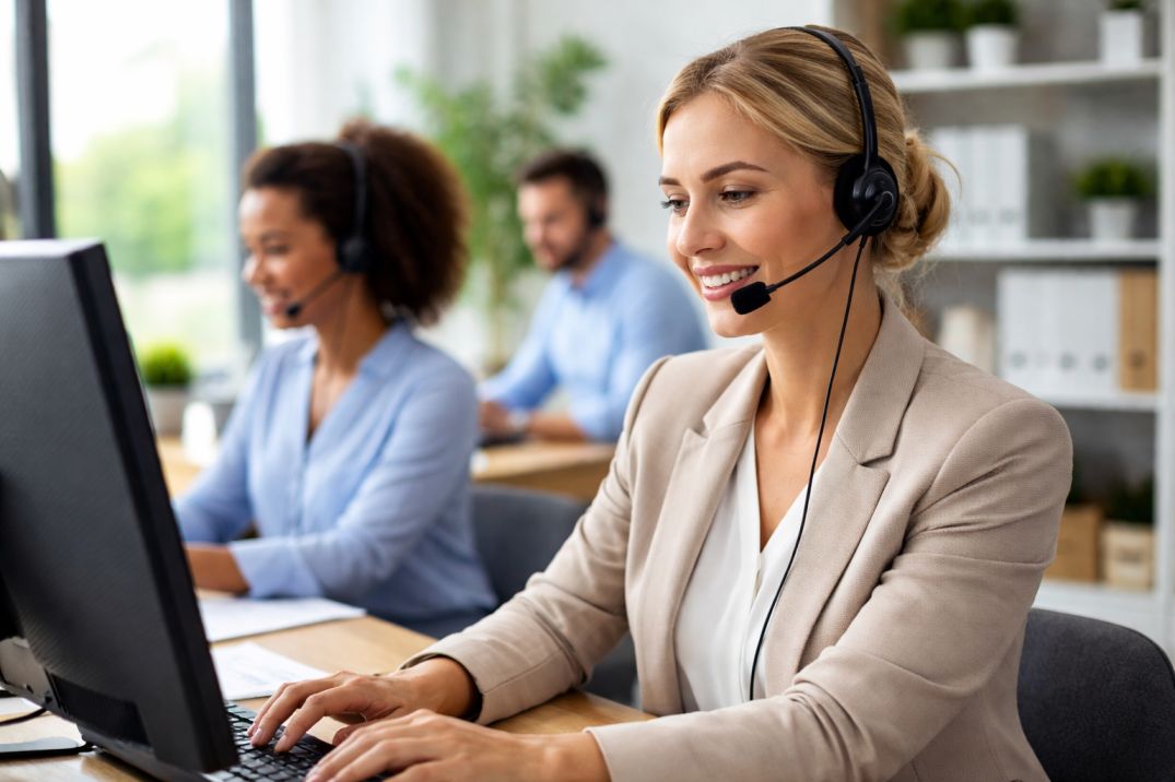 Professional call answering services for small businesses with virtual receptionists handling customer calls in a modern office environment